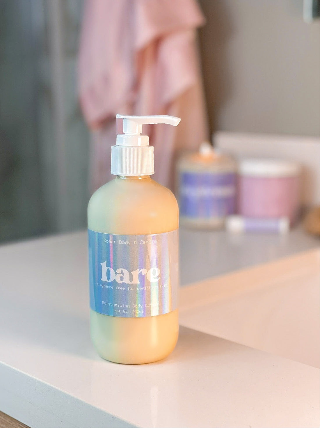 Bare Body Lotion sitting on a bathroom counter, featuring hemp oil for moisturizing with no fragrance, for sensitive skin. Cruelty-free, vegan, and sustainably packaged.