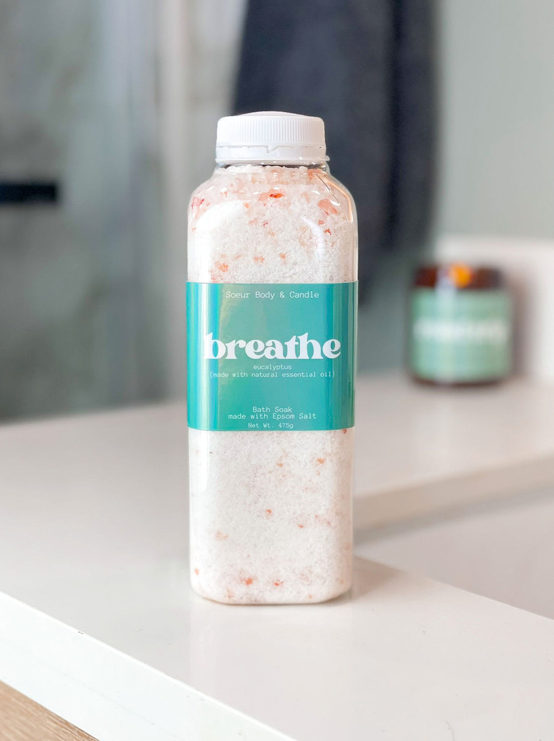 Breathe bath soak made with eucalyptus essential oil on a bathroom counter, featuring Epsom Salt for muscle relaxation and Himalayan Pink Salt, rich in essential minerals like potassium, calcium, and magnesium.