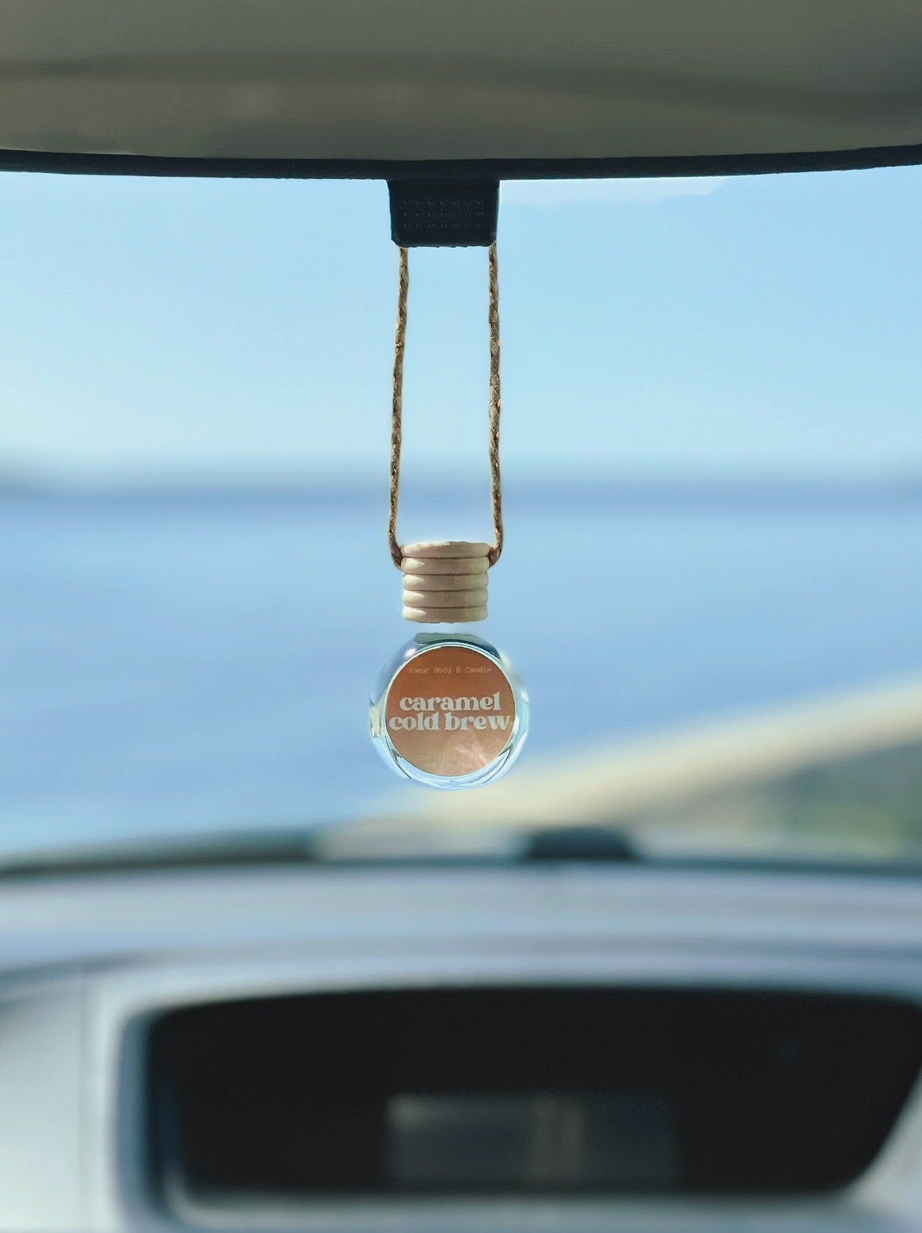 Caramel Cold Brew car diffuser with scents of cold brew coffee, sweet cream, and caramel. Cruelty-free, vegan, handmade, paraben and phthalate free, and sustainably packaged.