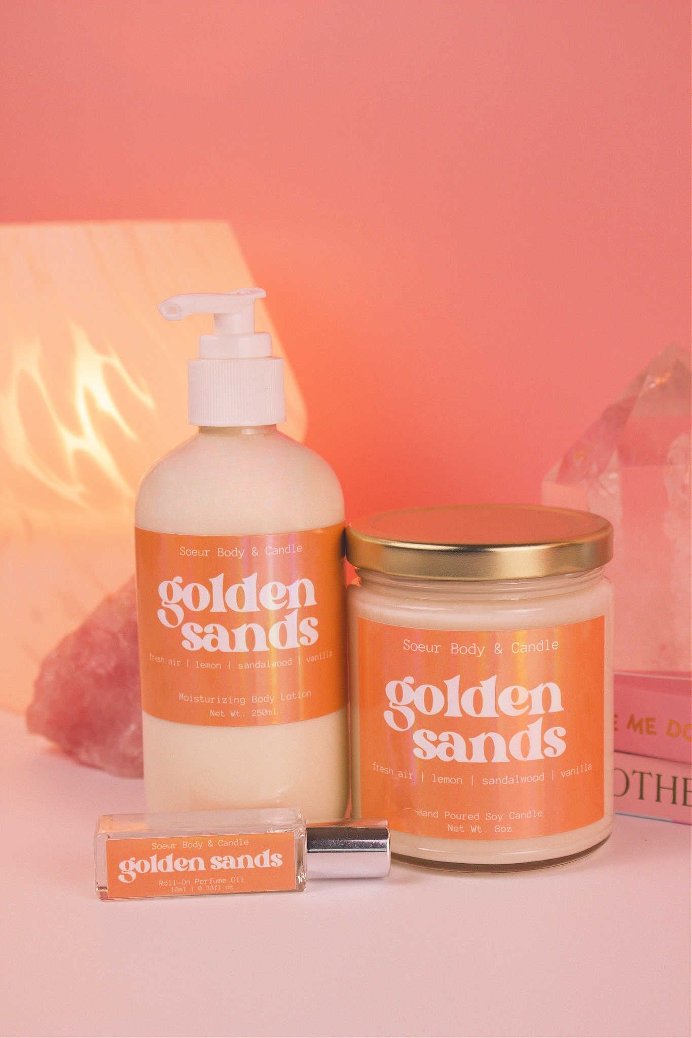 Golden Sands roll-on perfume, lotion, and candle together, evoking its fresh and inviting blend of fresh air, lemon, sandalwood, and vanilla.