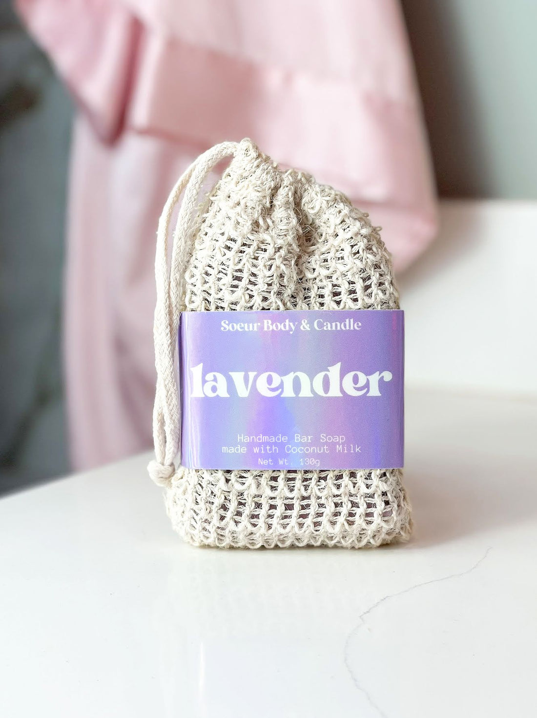 Lavender bar soap made with natural essential oil, sitting on a bathroom counter. Made with nourishing shea butter, coconut oil, and other hydrating oils. Cruelty-free, vegan, and sustainably packaged.