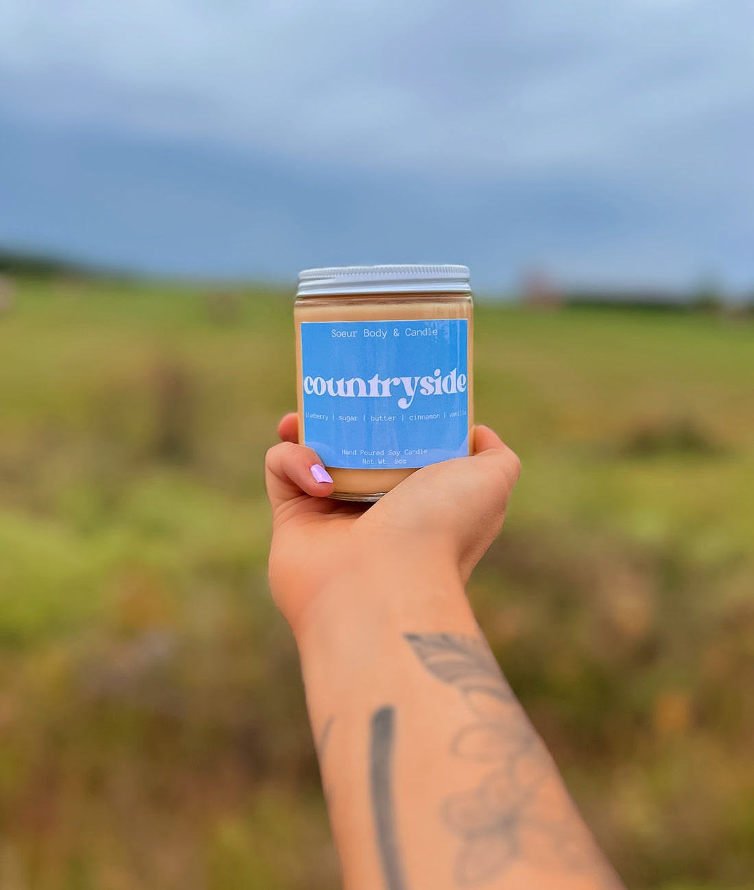 Countryside Soy Wax Candle with scents of blueberry, sugar, butter, cinnamon, and vanilla that lasts up to 45 hours! Cruelty-free, vegan, handmade, paraben and phthalate free, and sustainably packaged.