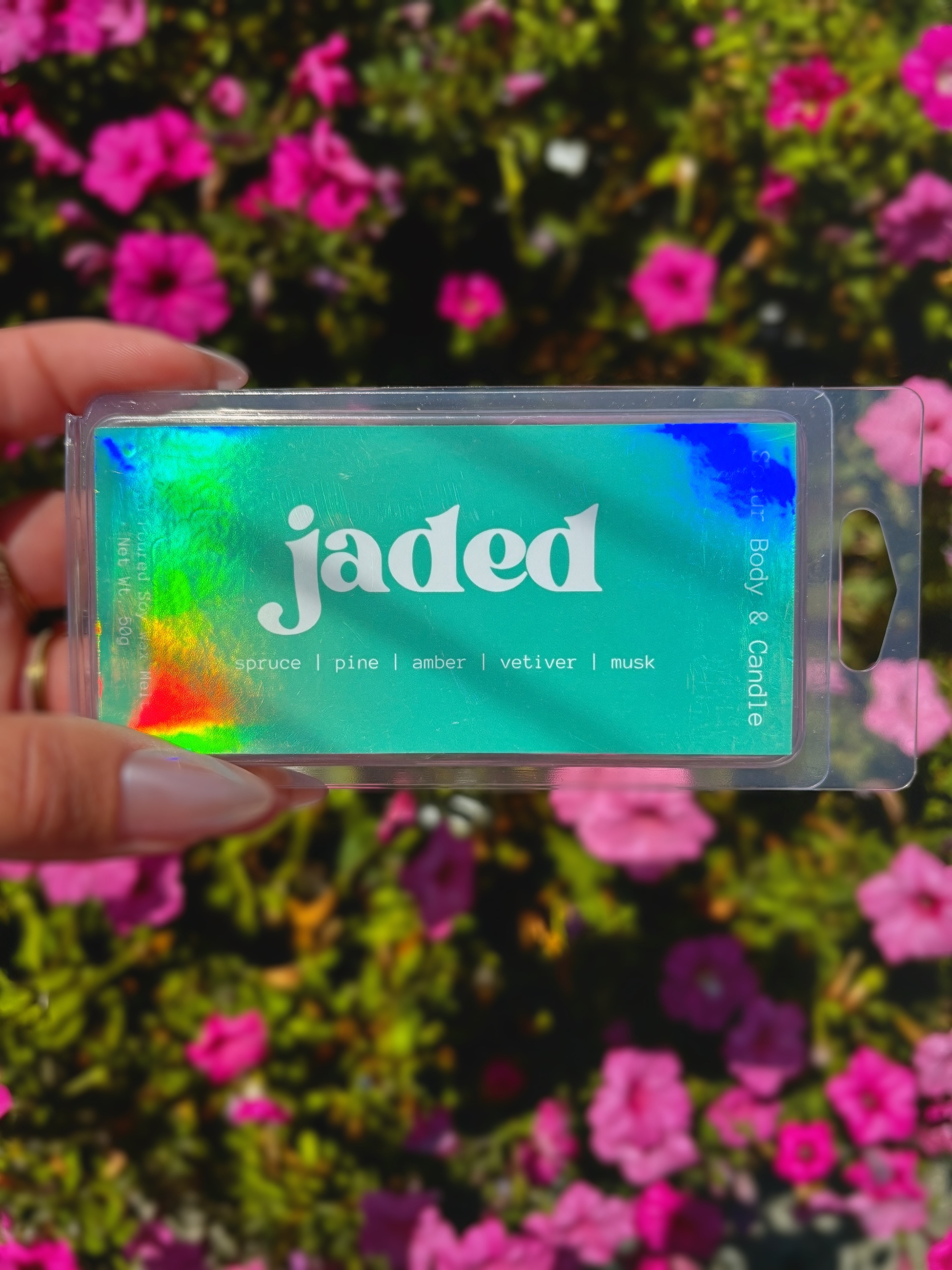 A hand holds a clear plastic package of &